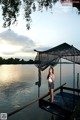 A woman standing on a dock with a net over her head.